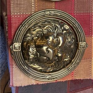 Heavy brass lion head door knockers.